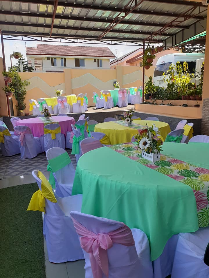 Outdoor summer garden party with rustic wood tables and floral arrangements